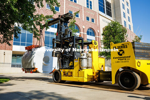 Workers use a crane to lift the new MRI scanner into Memorial Stadium. The new scanner will be used 