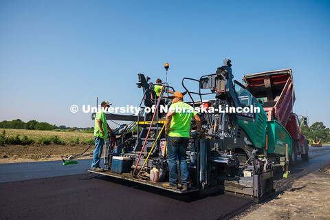 Construction crews pave Foundry Road in South Sioux City using asphalt made with recycled plastic ba
