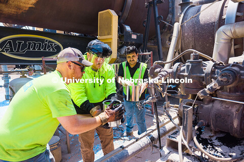 Nitish Bastola, PhD Civil Engineering student at UNL, collects oil samples for study with the help o