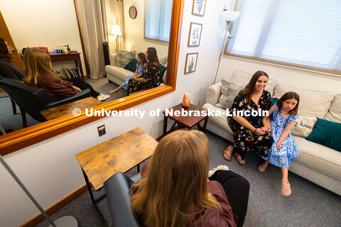 Jamie Buhrman sits with her daughter, seven-year-old Stella, in one of the therapy rooms in the Coup