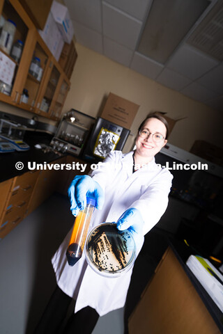 Erin Carr, a postdoctoral research associate in chemical and biomolecular engineering, holds up a pe
