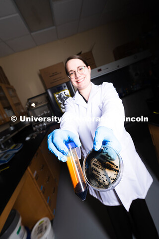 Erin Carr, a postdoctoral research associate in chemical and biomolecular engineering, holds up a pe