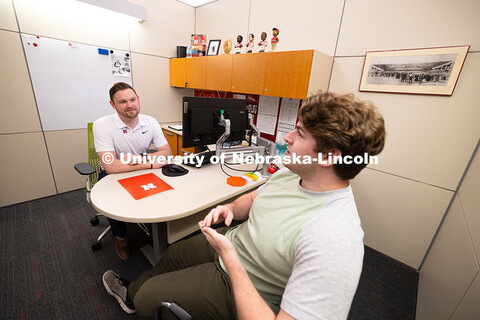 Adam Christiansen, Academic Navigator in the Explore Center, speaks with Jacob Behnk, a senior study