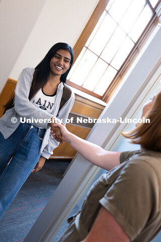 Laura Britten, Academic Navigator in the Explore Center, shakes hands with Swati Yadav, a sophomore 