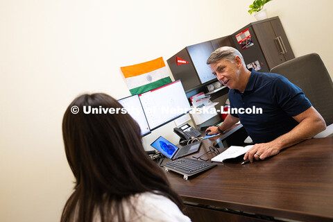 Dave Nebel speaks with Mireu Ryu, a senior studying computer science, in his office in Hawks Hall. N