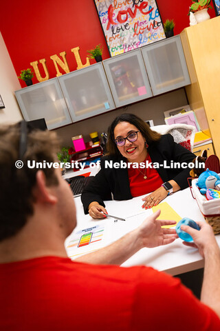 Mari Beck talks with Jacob Behnk, a senior studying Spanish and global studies, in her office in the