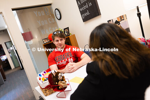 Jacob Behnk, a senior studying Spanish and global studies, speaks with Mari Beck in her office in th