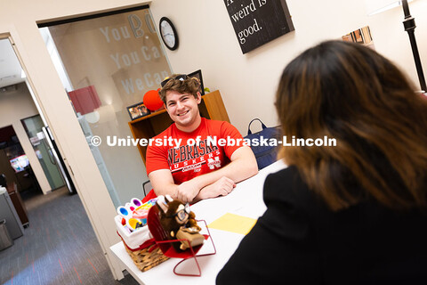Jacob Behnk, a senior studying Spanish and global studies, speaks with Mari Beck in her office in th
