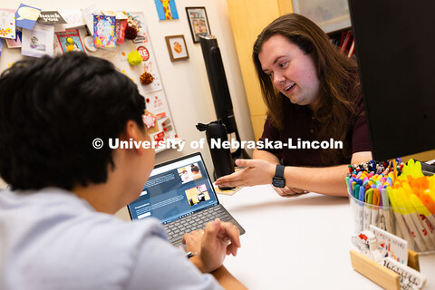 Jordan Heim chats with Jimmy Truong, a junior studying supply chain management, in his office in the