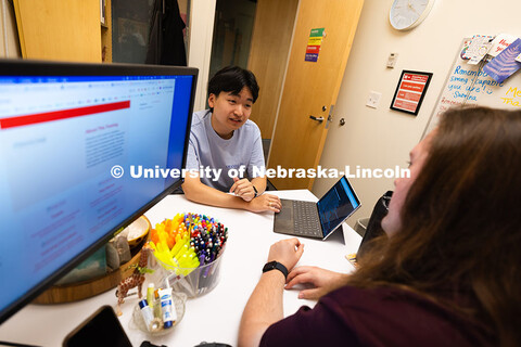 Jimmy Truong, a junior studying supply chain management, chats with Jordan Heim in his office in the