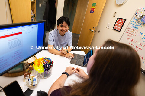 Jimmy Truong, a junior studying supply chain management, chats with Jordan Heim in his office in the