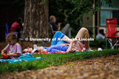 Spectators lay on their backs looking up at the sky during the intermission of Sam Greenfield’s pe