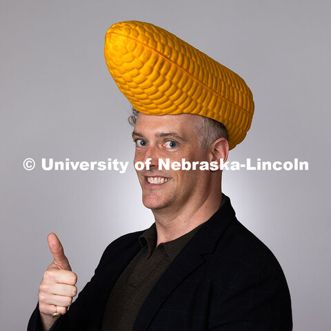 Studio portrait of Robert Russell, Director for Center for Academic Success and Transition, dons a c