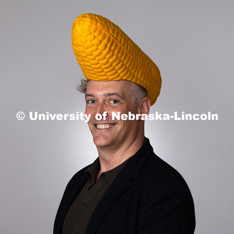 Studio portrait of Robert Russell, Director for Center for Academic Success and Transition, dons a c