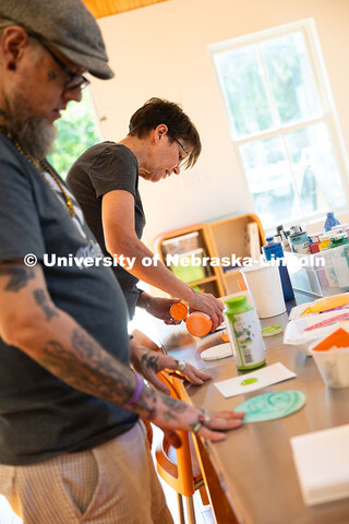 Jean Stryker, creative arts director for F Street Neighborhood Church, pours paint onto a small piec