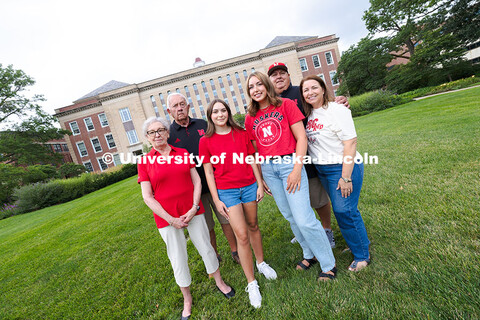 Sisters Madison and Lauren Haring pose with their family in front of Love Library. The Haring family