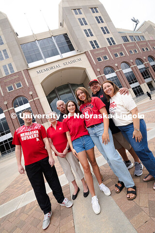 Sisters Madison and Lauren Haring pose with their family, plus Kevin Coleman, outside of Memorial St