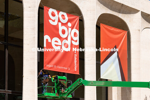 Justin DeBoer (left) and Geraldo Martinez (right), both exteriors technicians at UNL, adjust the cab
