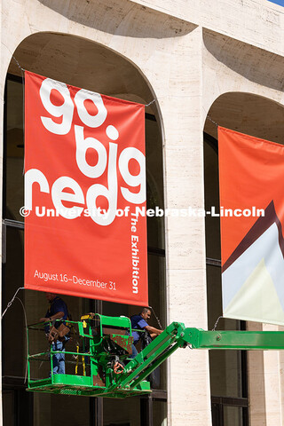 Justin DeBoer (left) and Geraldo Martinez (right), both exteriors technicians at UNL, adjust the cab