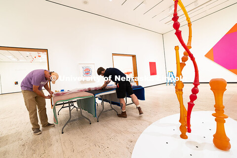 Delan Lonowksi and Quentin Fortney, on-call exhibition technicians for the Sheldon Museum of Art, un