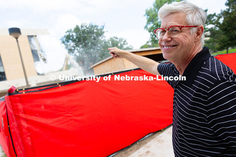 Peter Eklund, Professor of Music and Choral Director, points toward where his office was previously 