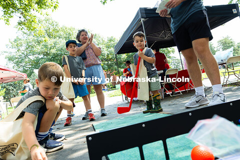 Three-year-old Carson Kolbo gets applause from his grandmother after hitting a ball through a target