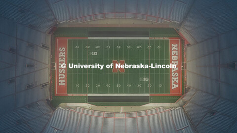 Aerial view of Memorial Stadium lights flooding Tom Osborne Field at sunrise. August 12, 2025. 