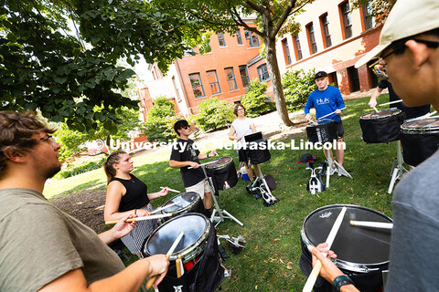 The Cornhusker Marching Band percussionists practice in the shade during Marching Band camp. August 