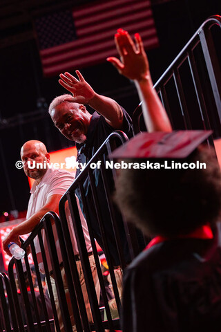 Jordan Ramsey leans over the railing to give his daughter, Jordan Ramsey, a high five as she enters 