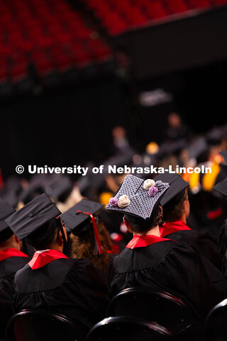A graduate crocheted a cover and flowers for their cap for the summer commencement ceremony. Summer 