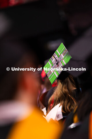 A graduate's cap is decorated with a pedestrian friendly intersection. Summer Commencement ceremony 