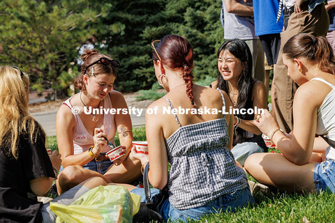 Freshman, Sarah Nielsen and Sloan Inbody laugh while enjoying ice cream from the Dairy Store at the 