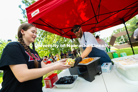 Abbie Taber, a senior studying flute performance, gets a bowl of nachos from Jake Dietrich during th
