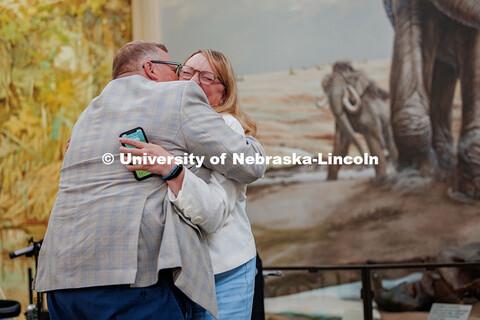 Mike Zeleny hugs his wife, Amy Zeleny, during his farewell reception in Morrill Hall. August 21, 202