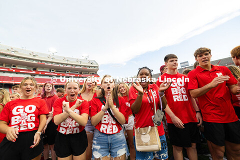 Students cheer in Memorial Stadium as they form an “N” on the Memorial Stadium field for the cla