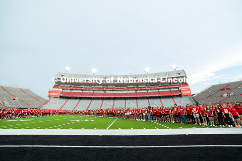 Freshman students form an N on the Memorial Stadium field for the class of 2029 photo during the 202