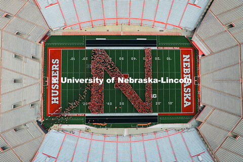 Freshman students form an N on the Memorial Stadium field for the class of 2029 photo during the 202