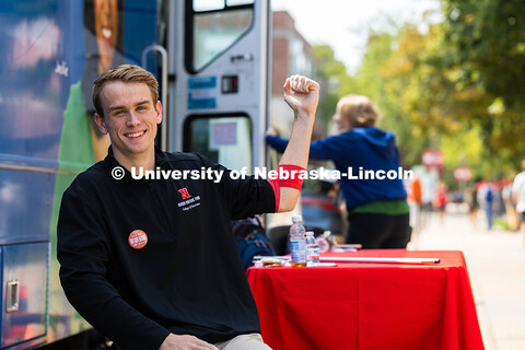 Maddock Oberzan, a junior studying finances and economics, holds up a fist after donating blood duri
