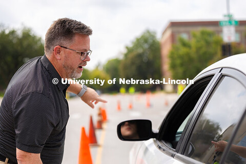 Josh Overocker, Associate Vice Chancellor for Student Life, directs a student toward the Memorial St