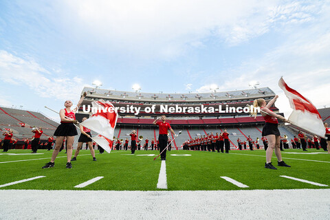 Tanner Maas, one of the 2025 drum majors, holds a salute as the band plays "There is No Place Like N