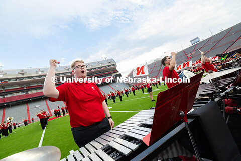 Pit members yell "Go Big Red" as the band plays "There is No Place Like Nebraska". Cornhusker Marchi