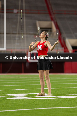Twirler Britney Berry keeps her eye on not one, but three batons during her performance within the m