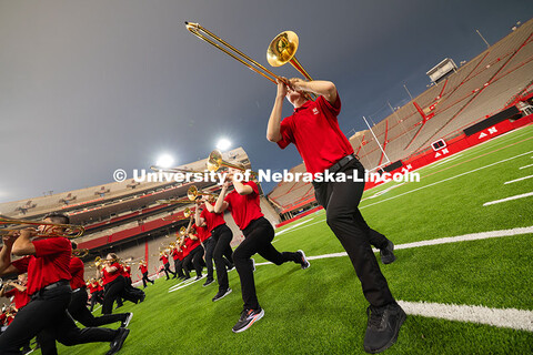 A smattering of raindrops fall on members of the trombone line as they pose during one of several sp