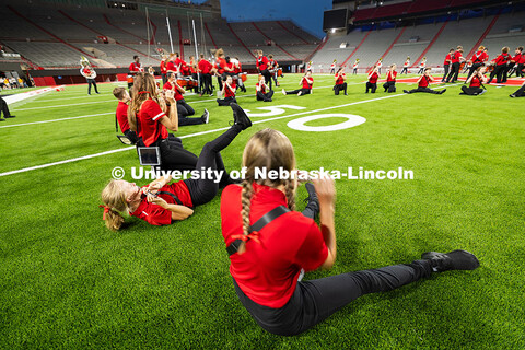 Piccolo players sit in goofy positions for a silly rendition of "There is No Place Like Nebraska" du