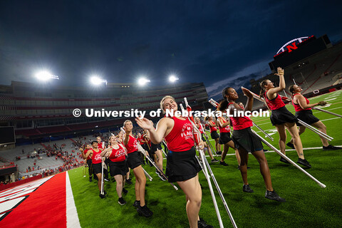 Color guard members dance out of Memorial Stadium after the band exhibition. Cornhusker Marching Ban