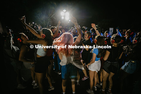 Students rush back in after the dance circle while listening to Silent Disco during the Big Red Welc