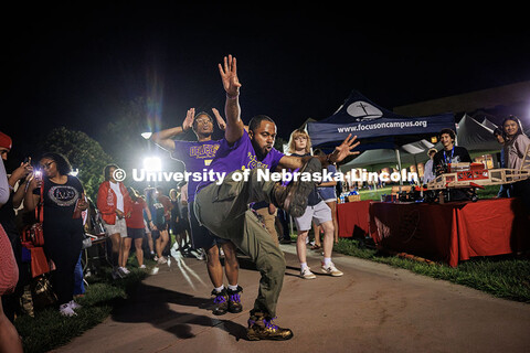 Matt Meyer (front) and Da’Von George do their Chapter March for Omega Psi Phi in the green space a