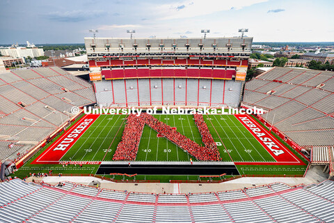 Freshman students form an N on the Memorial Stadium field for the class of 2029 photo during the 202