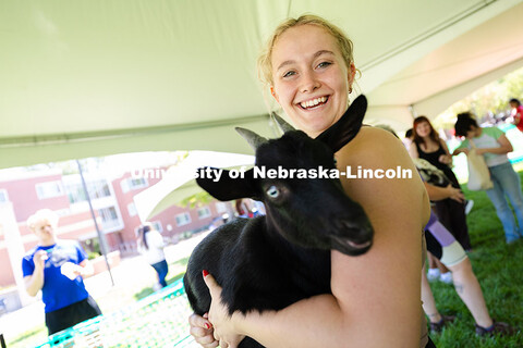 Hailee Schull smiles while holding a goat. Schull is a sophomore studying nursing. Goat yoga is part