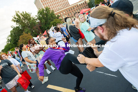 Victorya Genao, a first-year student studying criminal justice, kicks at a board held by Trent Gray,